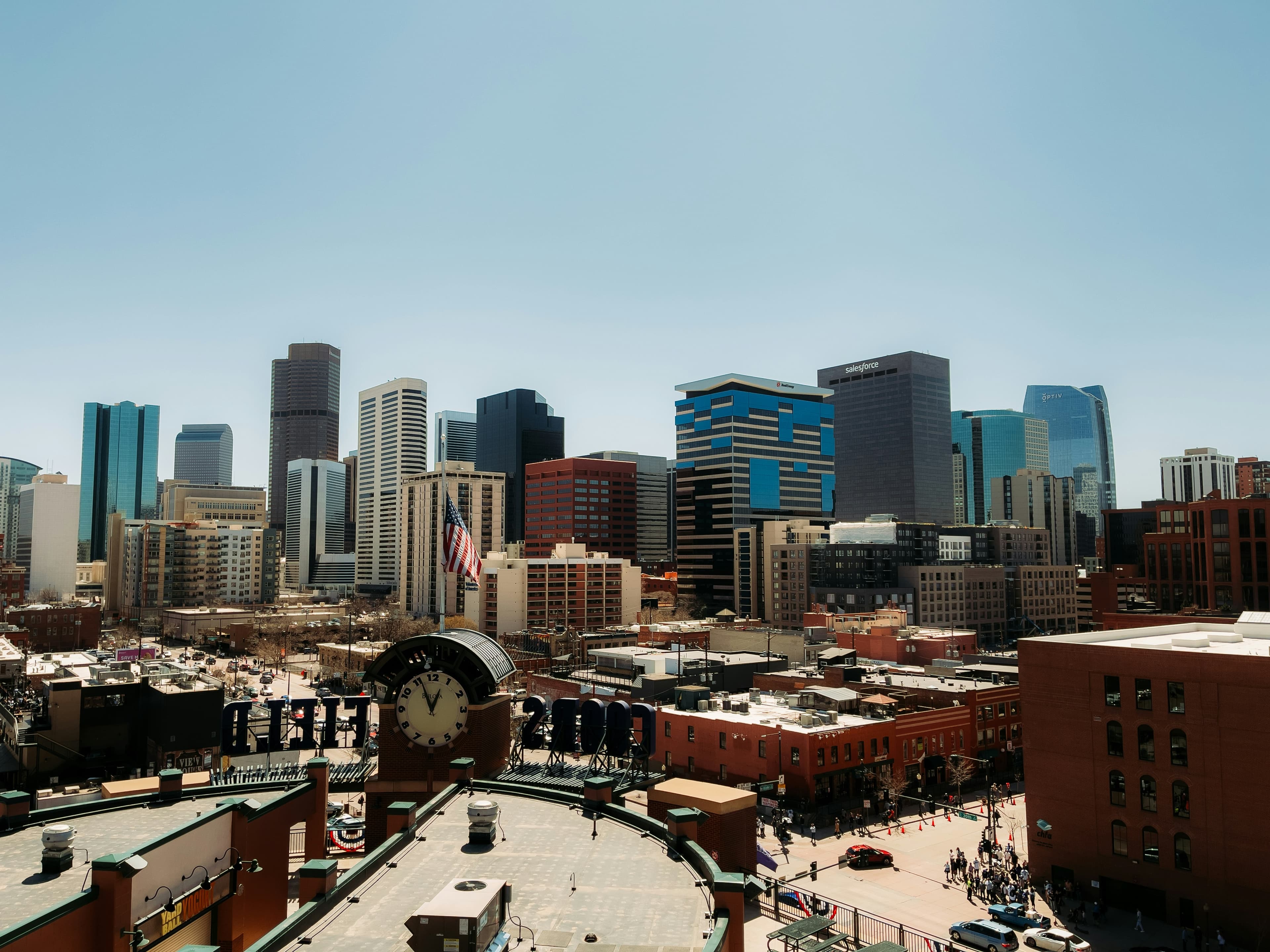 Denver skyline at dusk with rooftop social scene